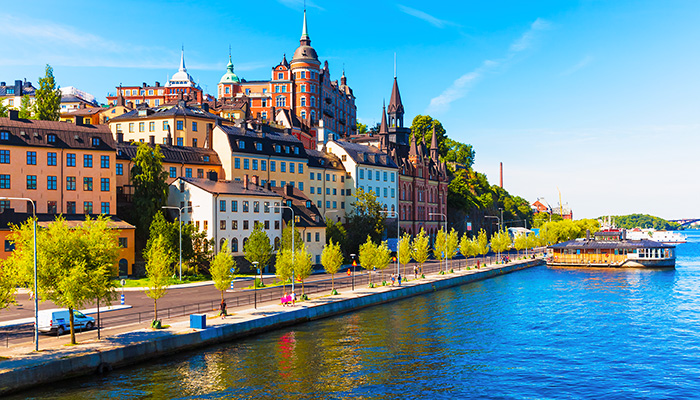Sun shines on waterfront buildings in Stockholm Sweden